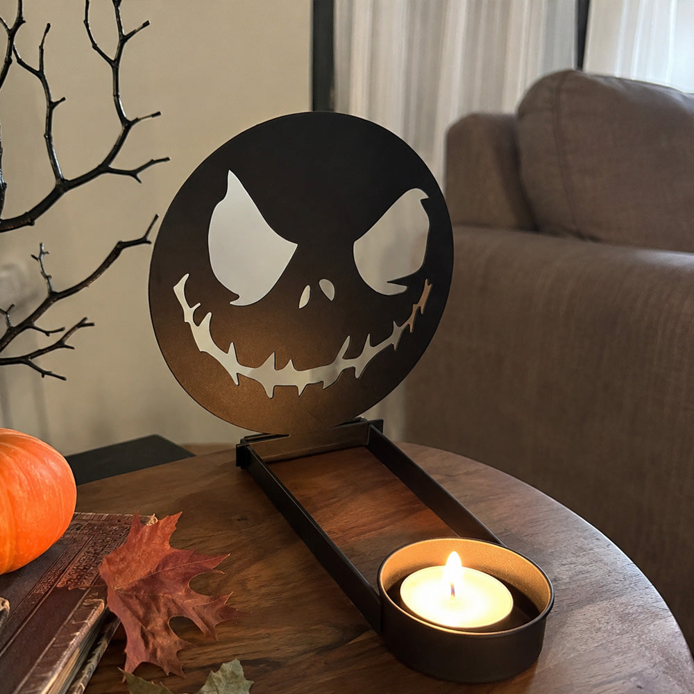 Scary faces halloween metal candle holder casting a spooky shadow on the wall