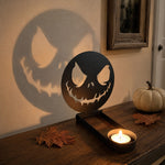 Scary faces halloween metal candle holder casting a spooky shadow on the wall