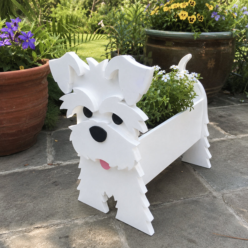 Schnauzer dog planter filled with fresh flowers is placed in the garden
