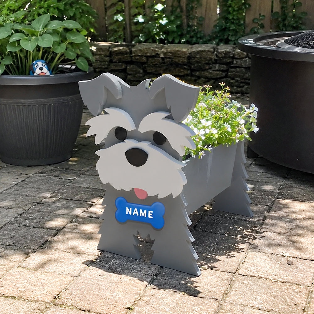 Schnauzer dog planter filled with fresh flowers is placed in the garden