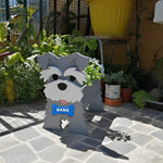 Schnauzer dog planter filled with fresh flowers is placed in the garden