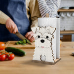 Schnauzer Wooden Dog Paper Towel Holder displayed on a kitchen countertop with a freestanding paper towel roll
