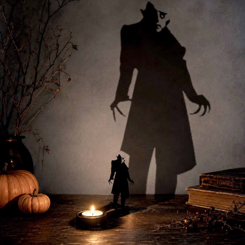Shadow stalker halloween metal candle holder casting a spooky shadow on the wall