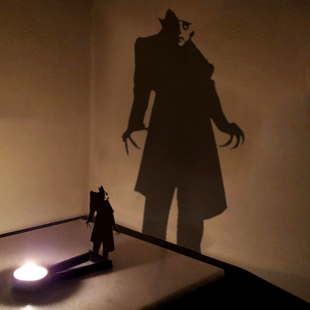 Shadow stalker halloween metal candle holder casting a spooky shadow on the wall