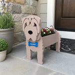 Shar Pei dog planter filled with fresh flowers is placed in the garden
