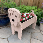Shar Pei dog planter filled with fresh flowers is placed in the garden