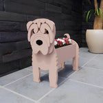 Shar Pei dog planter filled with fresh flowers is placed in the garden