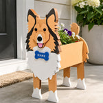 Sheltie-Shetland Sheepdog planter filled with fresh flowers is placed in the garden