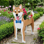 Shiba Inu dog planter filled with fresh flowers is placed in the garden.