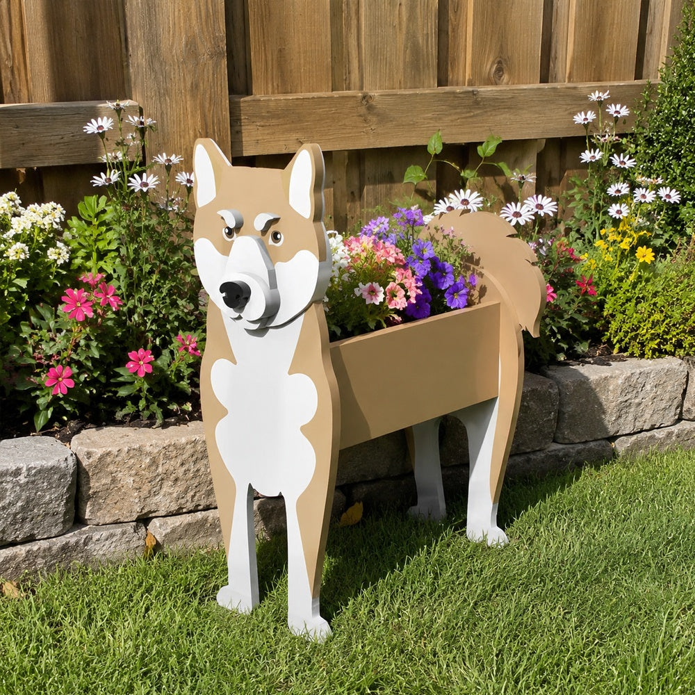 Shiba Inu dog planter filled with fresh flowers is placed in the garden.
