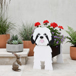 Shih Tzu dog planter filled with fresh flowers is placed in the garden