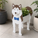 Siberian Husky dog planter filled with fresh flowers is placed in the garden