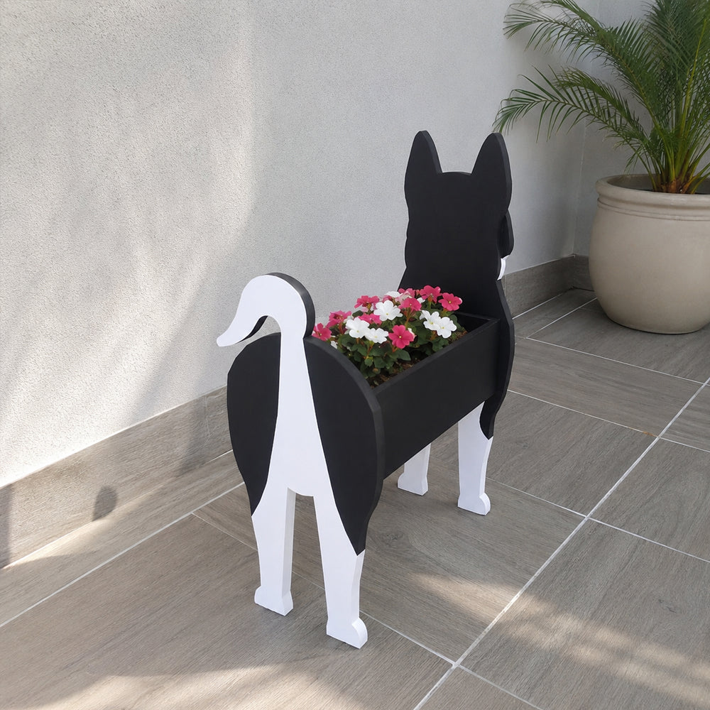 Siberian Husky dog planter filled with fresh flowers is placed in the garden