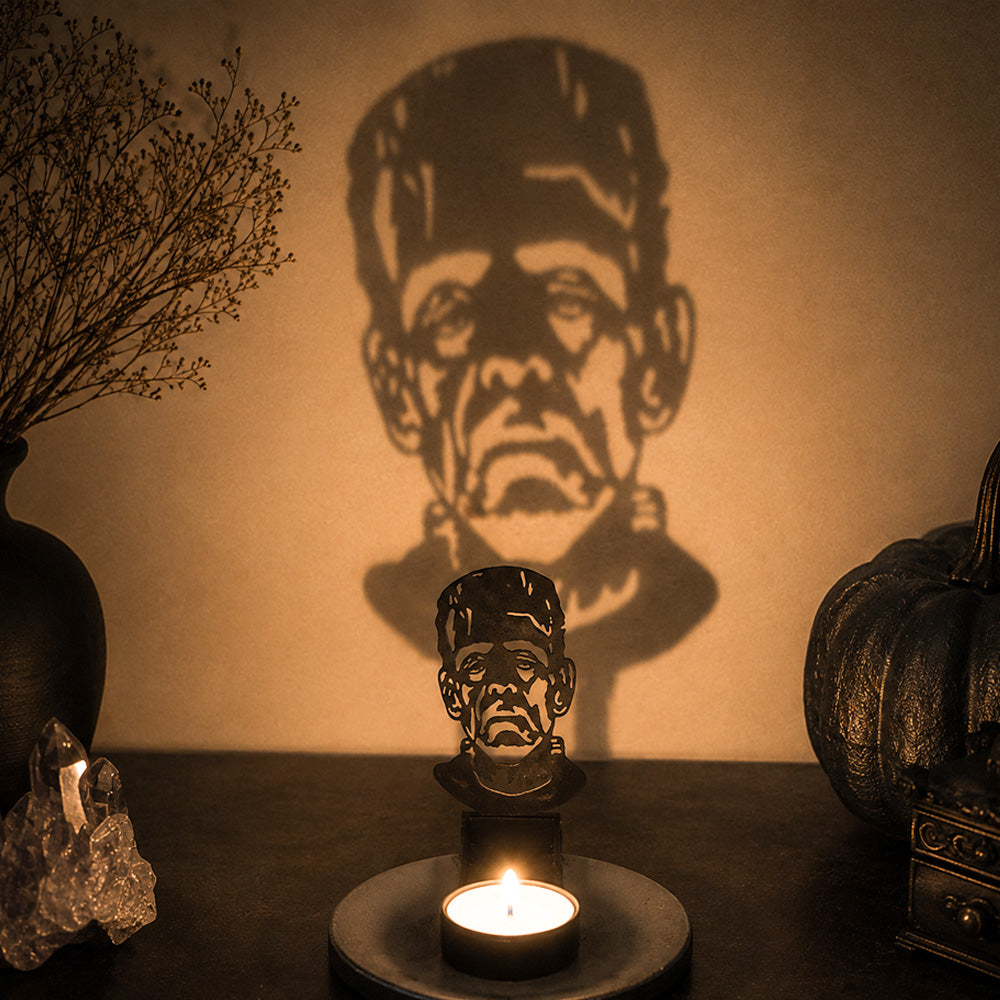 Sinister face halloween metal candle holder casting a spooky shadow on the wall