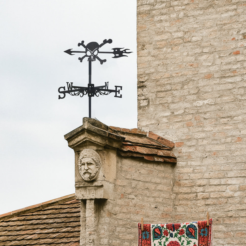 Skull and crossbones metal weather vane with directional arrows and mounting rod, outdoor roof and garden decoration
