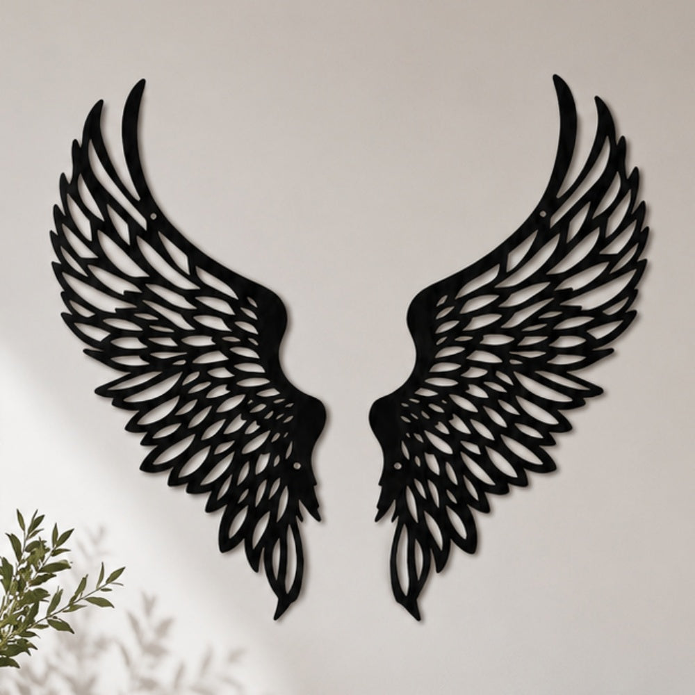 Black metal Soaring Angel Wings wall art with intricate cutout details displayed on the wall