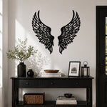 Black metal Soaring Angel Wings wall art with intricate cutout details displayed on the wall