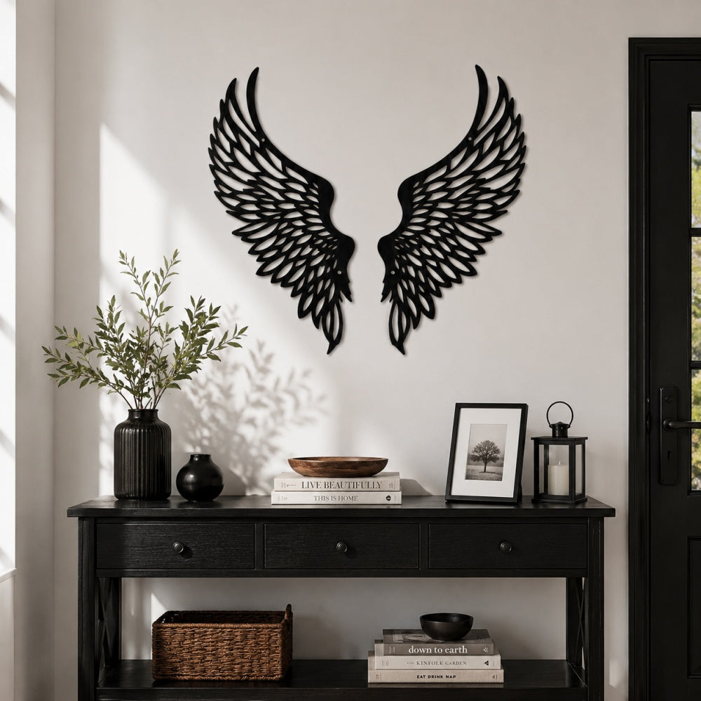 Black metal Soaring Angel Wings wall art with intricate cutout details displayed on the wall