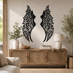 Black metal Soaring Angel Wings wall art with intricate cutout details displayed on the wall