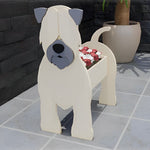 Soft Coated Wheaten Terrier dog planter filled with fresh flowers is placed in the garden