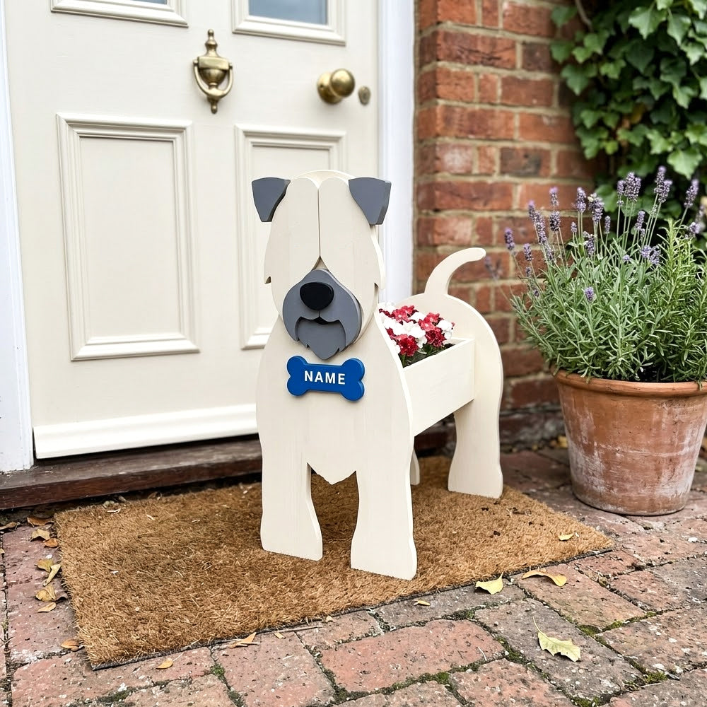 Soft Coated Wheaten Terrier dog planter filled with fresh flowers is placed in the garden