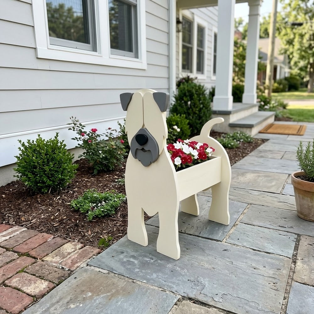 Soft Coated Wheaten Terrier dog planter filled with fresh flowers is placed in the garden