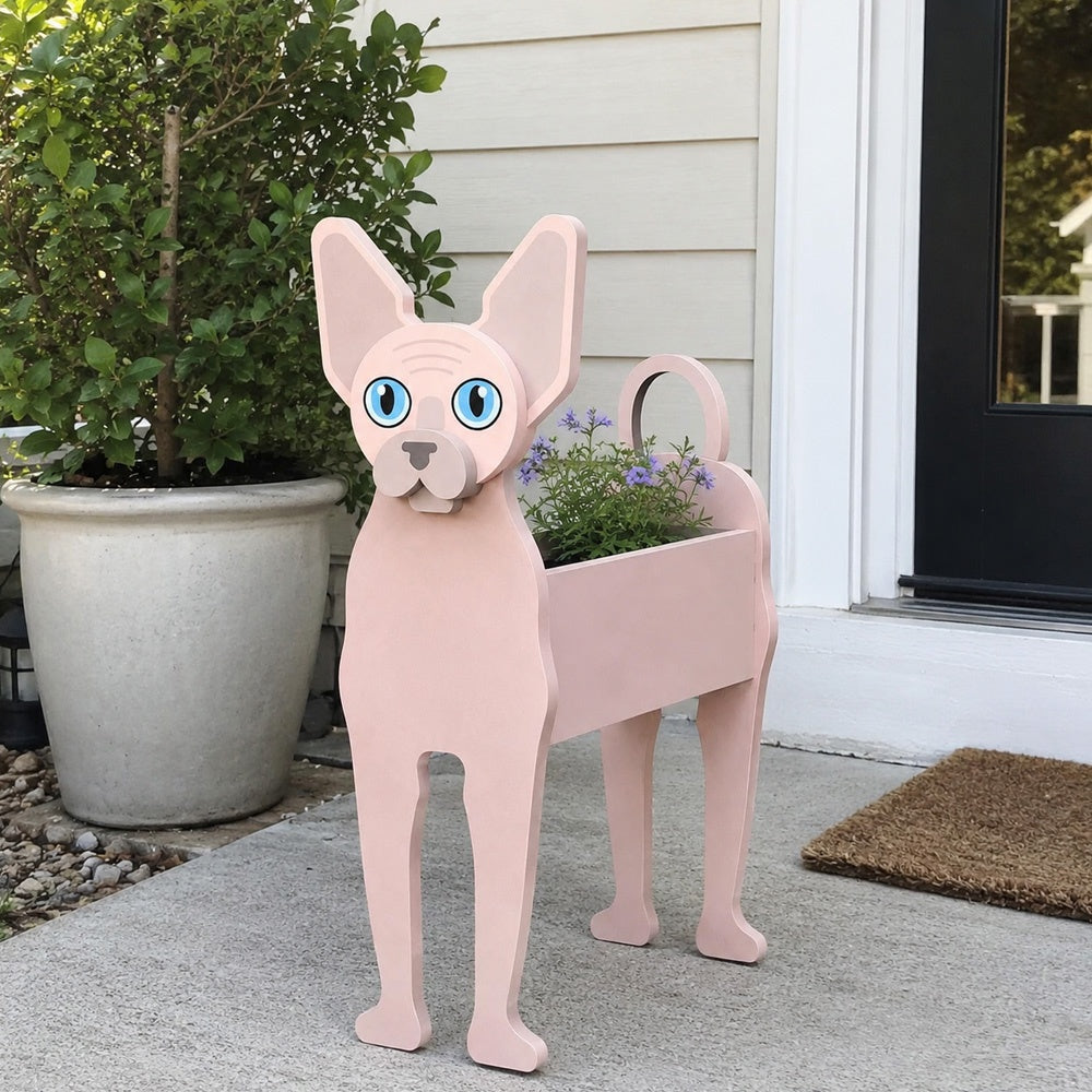 Sphynx cat planter filled with fresh flowers is placed in the garden