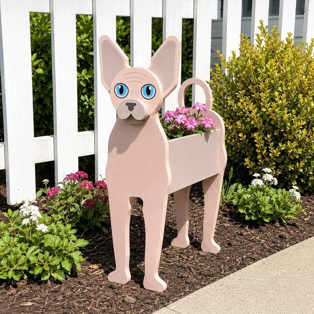 Sphynx cat planter filled with fresh flowers is placed in the garden