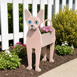 Sphynx cat planter filled with fresh flowers is placed in the garden