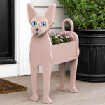 Sphynx cat planter filled with fresh flowers is placed in the garden