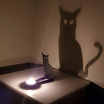 Spooky black cat halloween metal candle holder casting a spooky shadow on the wall