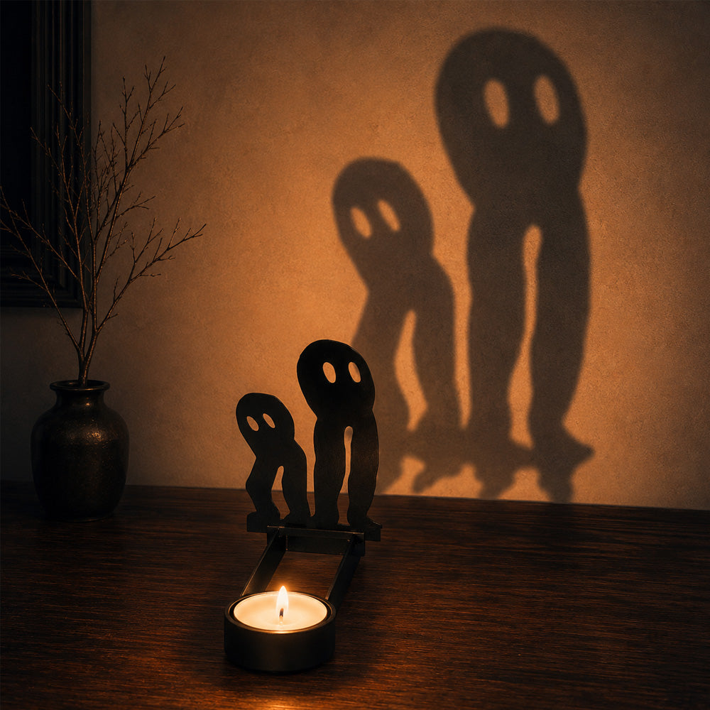 Spooky ghosts halloween metal candle holder casting a spooky shadow on the wall