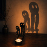 Spooky ghosts halloween metal candle holder casting a spooky shadow on the wall