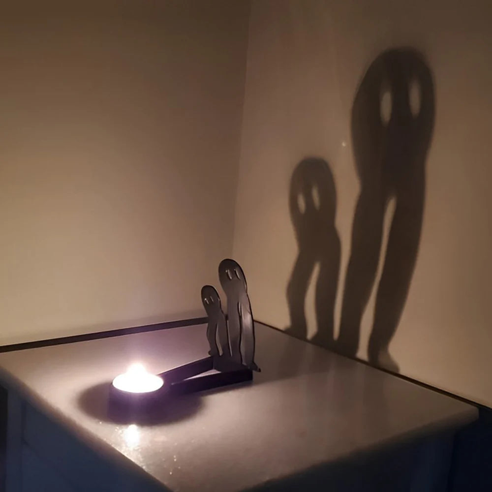 Spooky ghosts halloween metal candle holder casting a spooky shadow on the wall