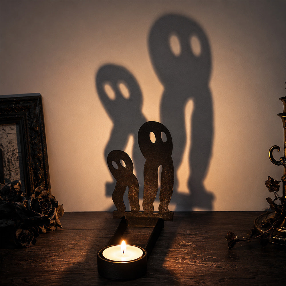 Spooky ghosts halloween metal candle holder casting a spooky shadow on the wall