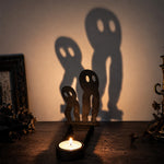 Spooky ghosts halloween metal candle holder casting a spooky shadow on the wall