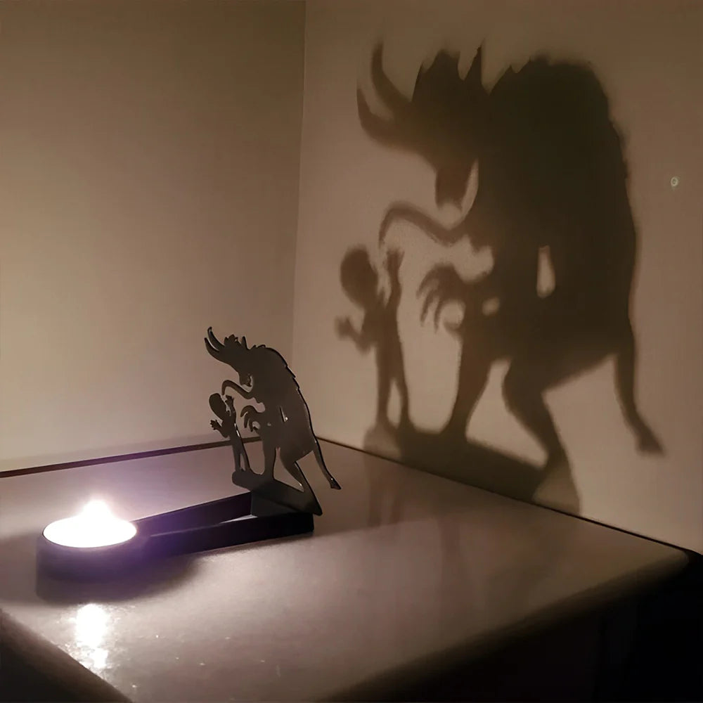 Spooky monster halloween metal candle holder casting a spooky shadow on the wall