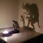 Spooky monster halloween metal candle holder casting a spooky shadow on the wall