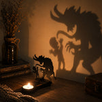 Spooky monster halloween metal candle holder casting a spooky shadow on the wall