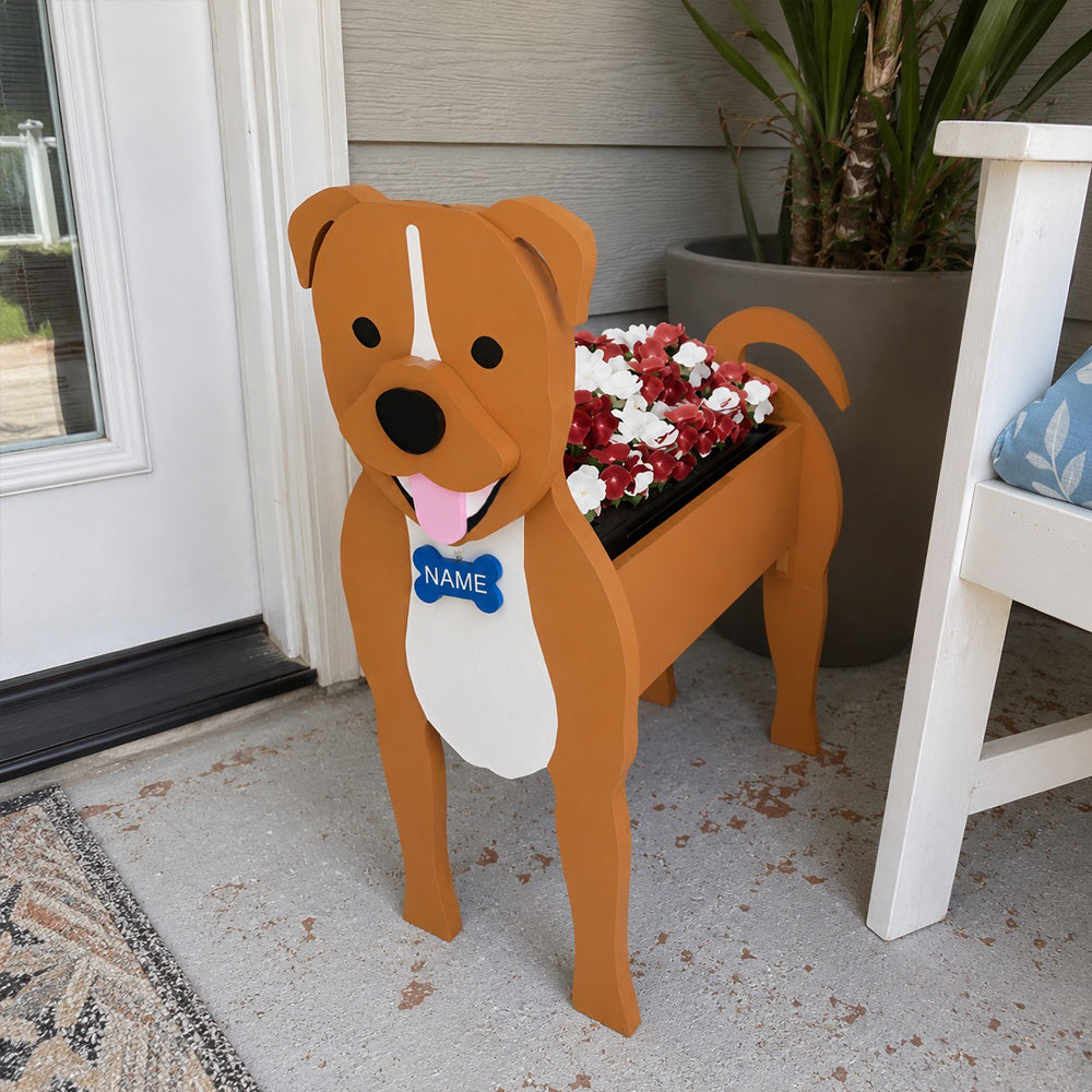 Staffordshire Bull Terrier dog planter filled with fresh flowers is placed in the garden