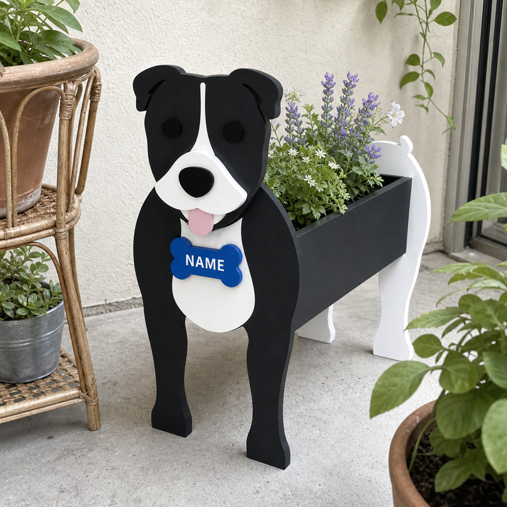 Staffordshire Bull Terrier dog planter filled with fresh flowers is placed in the garden