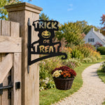Trick or treat pumpkin metal hanging basket bracket mounted on outdoor wall for plant decoration
