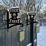 Trick or treat pumpkin metal hanging basket bracket mounted on outdoor wall for plant decoration