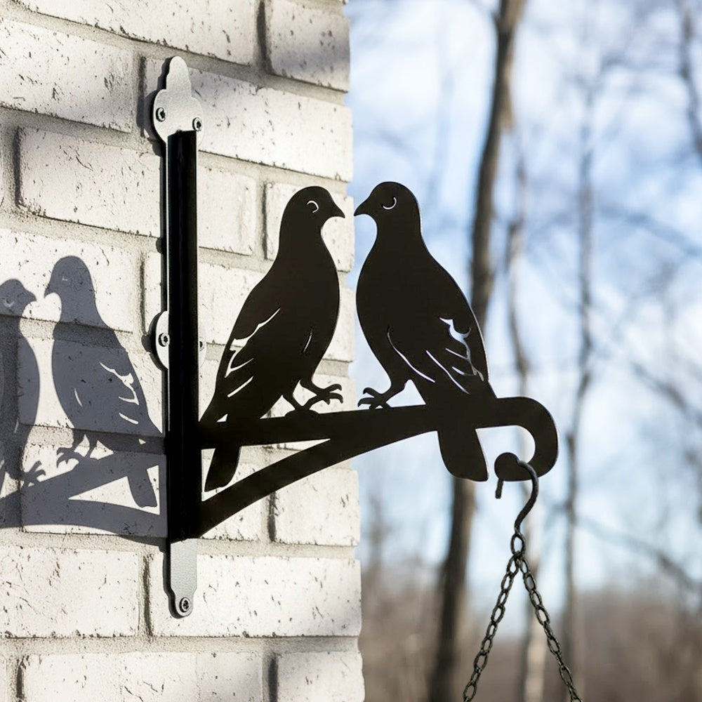 Two lovebirds on branch metal hanging basket bracket mounted on outdoor wall for plant decoration