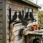 Two lovebirds on branch metal hanging basket bracket mounted on outdoor wall for plant decoration