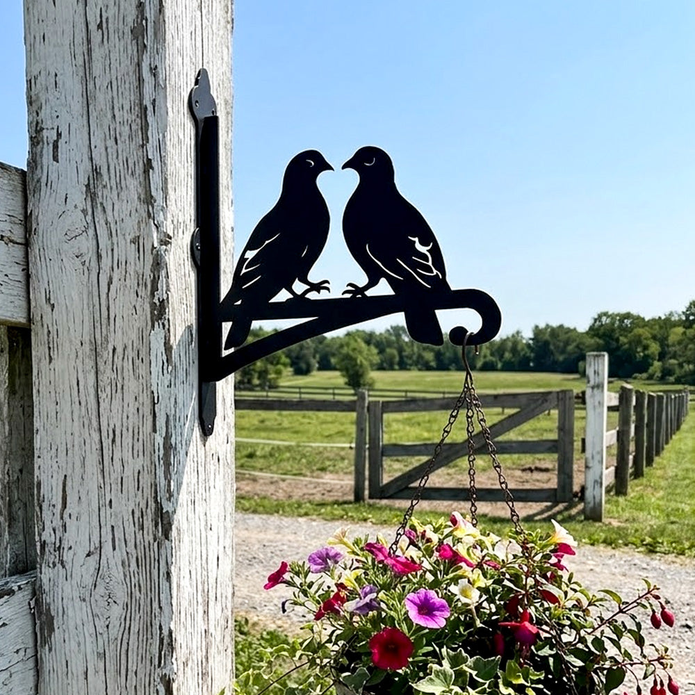 Two lovebirds on branch metal hanging basket bracket mounted on outdoor wall for plant decoration
