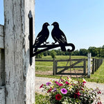 Two lovebirds on branch metal hanging basket bracket mounted on outdoor wall for plant decoration