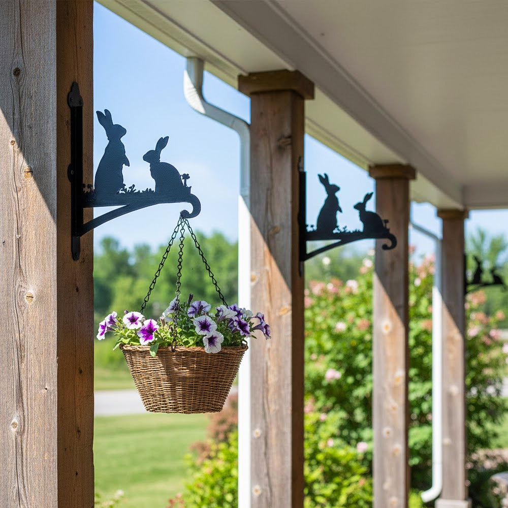Two rabbits metal hanging basket bracket mounted on outdoor wall for plant decoration
