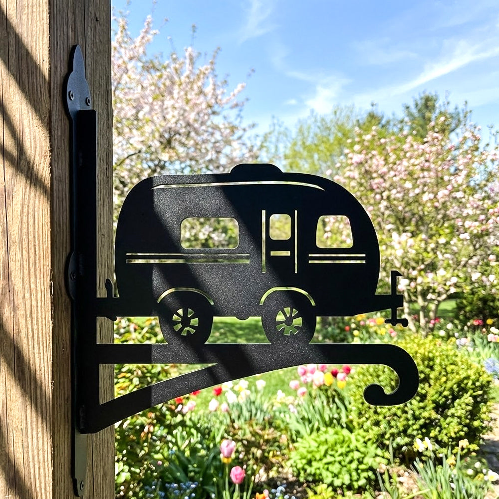 Vintage camper metal hanging basket bracket mounted on outdoor wall for plant decoration