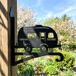 Vintage camper metal hanging basket bracket mounted on outdoor wall for plant decoration
